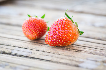 Red strawberry place on the wood plate