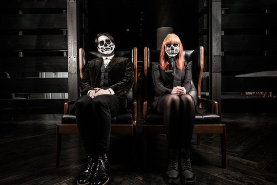 Evil day of the dead undead couple in chairs