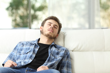 Tired man sleeping on a couch