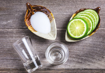 Shot glass with lemon and salt on the wood table