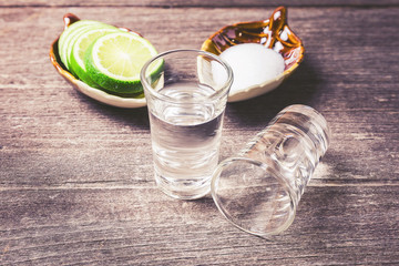Shot glass with lemon and salt on the wood table