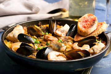 Traditional seafood paella in the pan