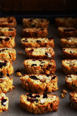 Baking homemade cantuccini with nuts, raisins and dried cranberries on a baking sheet