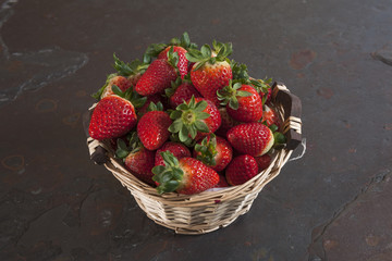 Basket of fresh strawberries on table, close up