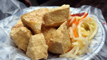 Fried stinky tofu with pickle vegetable and sauce on the side