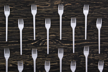 plastic forks on wooden background