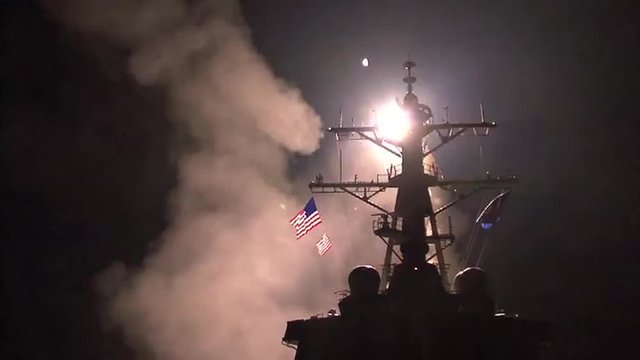 A U.S. Navy ship launches Tomahawk missiles towards Libyan targets during Operation Odyssey Dawn.