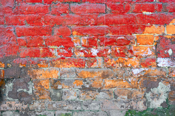Old brick wall painted in red texture, half weathered