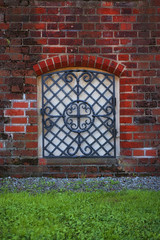 Fototapeta na wymiar Window in the old brick wall
