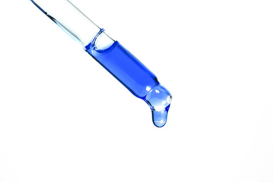 pipette with blue liquid transparent oil