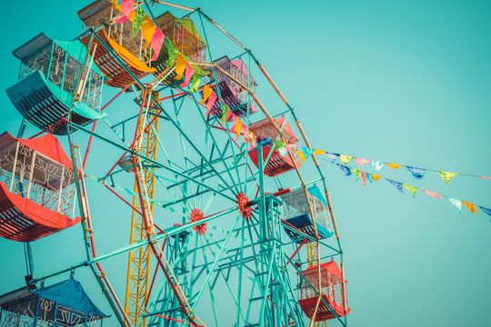 Ferris wheel on blue sky background vintage color