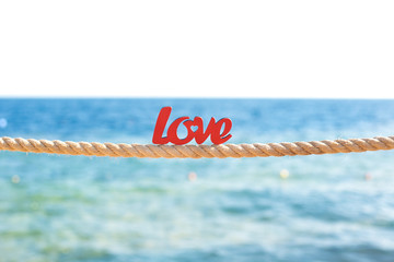 wooden word love on the background of the sea