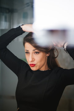 Woman combing her hair in the mirror