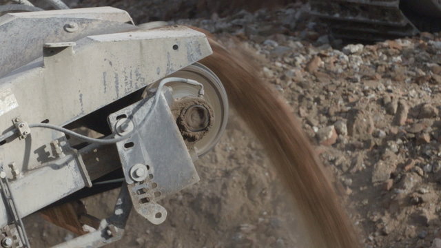 A screening machine on a construction site, separating soil from rubble after demolition.