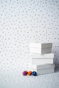 Three small Easter egga next to three white boxes on dotted background