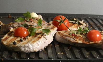 Assorted delicious grilled meat with vegetable over the coals on a barbecue in closeup