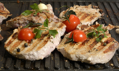 Assorted delicious grilled meat with vegetable over the coals on a barbecue in closeup