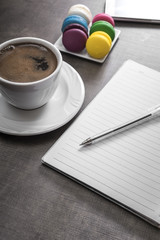 Cup of coffee  and colorful macaroons