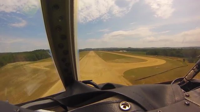 POV shots of a C-130 cargo plane landing on a dirt runway.