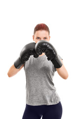Young girl with boxing gloves blocking