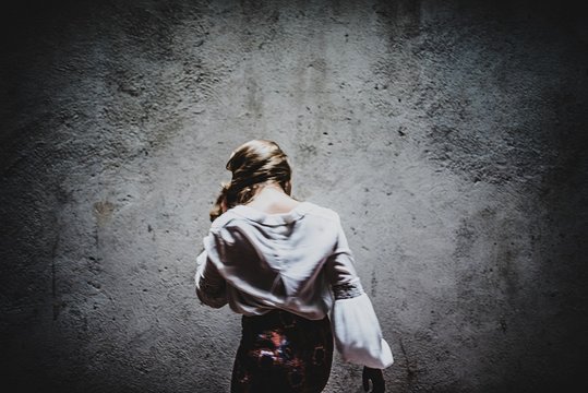 Back View of Woman in a Dark Room