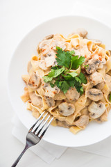 Pasta with creamy sauce, mushrooms and paprika top view