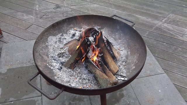 ein kleines Feuer in einer Metallschale