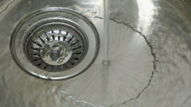 Drain the water in a steel sink in the kitchen