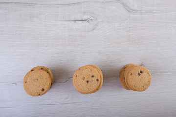 Chocolate cookies on wooden table. Cookies with chocolate and nuts