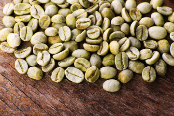 Heap of green coffee beans on table close up