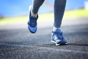 Sports woman legs in running movement