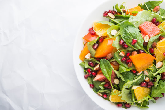 Fresh Salad With Fruits And Greens On White Background Top View With Space For Text. Healthy Food.