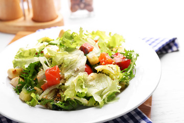 Tasty salmon salad on wooden table background