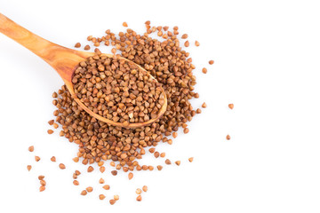 Uncooked buckwheat on wooden spoon