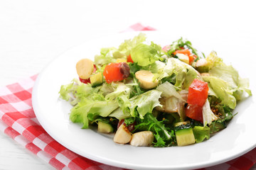 Tasty salmon salad on light wooden background