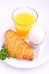 Weekend breakfast: croissants, egg and orange juice, white background