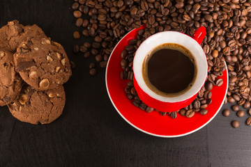 Good morning or Have a nice day message concept - bright red cup of frothy coffee with chocolate cookies, coffee beans