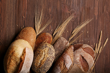 Fresh baked bread on the wooden background