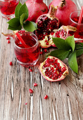 Fresh pomegranates and juice, selective focus