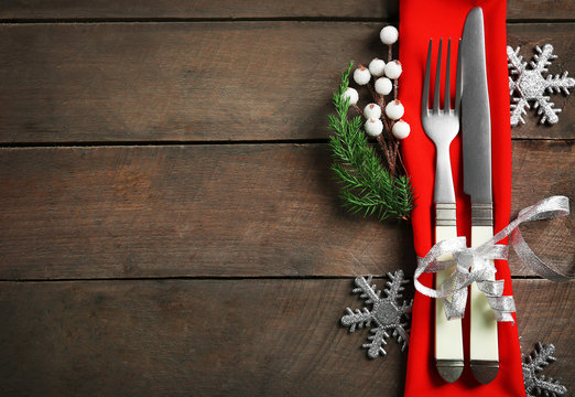 Christmas serving cutlery with napkin on a wooden background