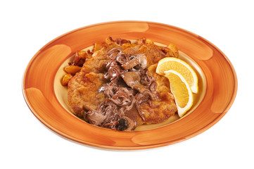 Schnitzel with mushrooms and mushroom sauce on a plate. Isolated on white