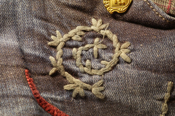 denim fabric with embroidery thread of gray in the form of a snail