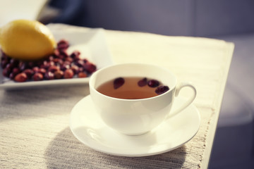 Rose hip and lemon tea on table in the room
