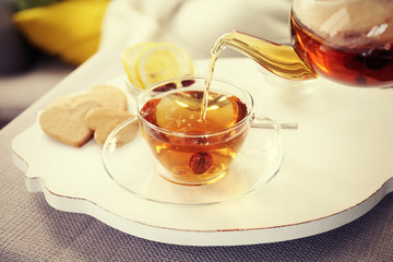 Pouring tea into cup, home atmosphere