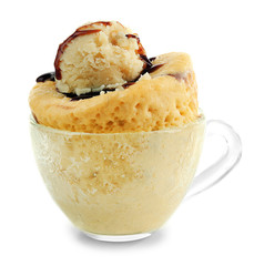 Mug cake with chocolate syrup isolated on white
