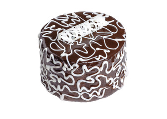 A chocolate cake with a white cream pattern isolated on white