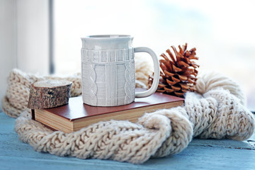Obraz na płótnie Canvas Beautiful winter composition on windowsill with cup of hot drink