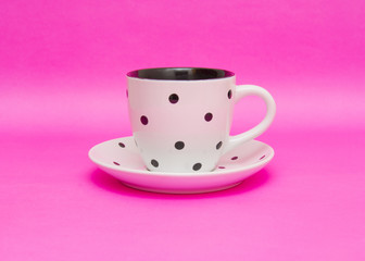 White cup isolated on pink background