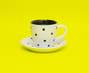 White cup isolated on yellow background