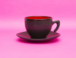 Black cup isolated on pink background